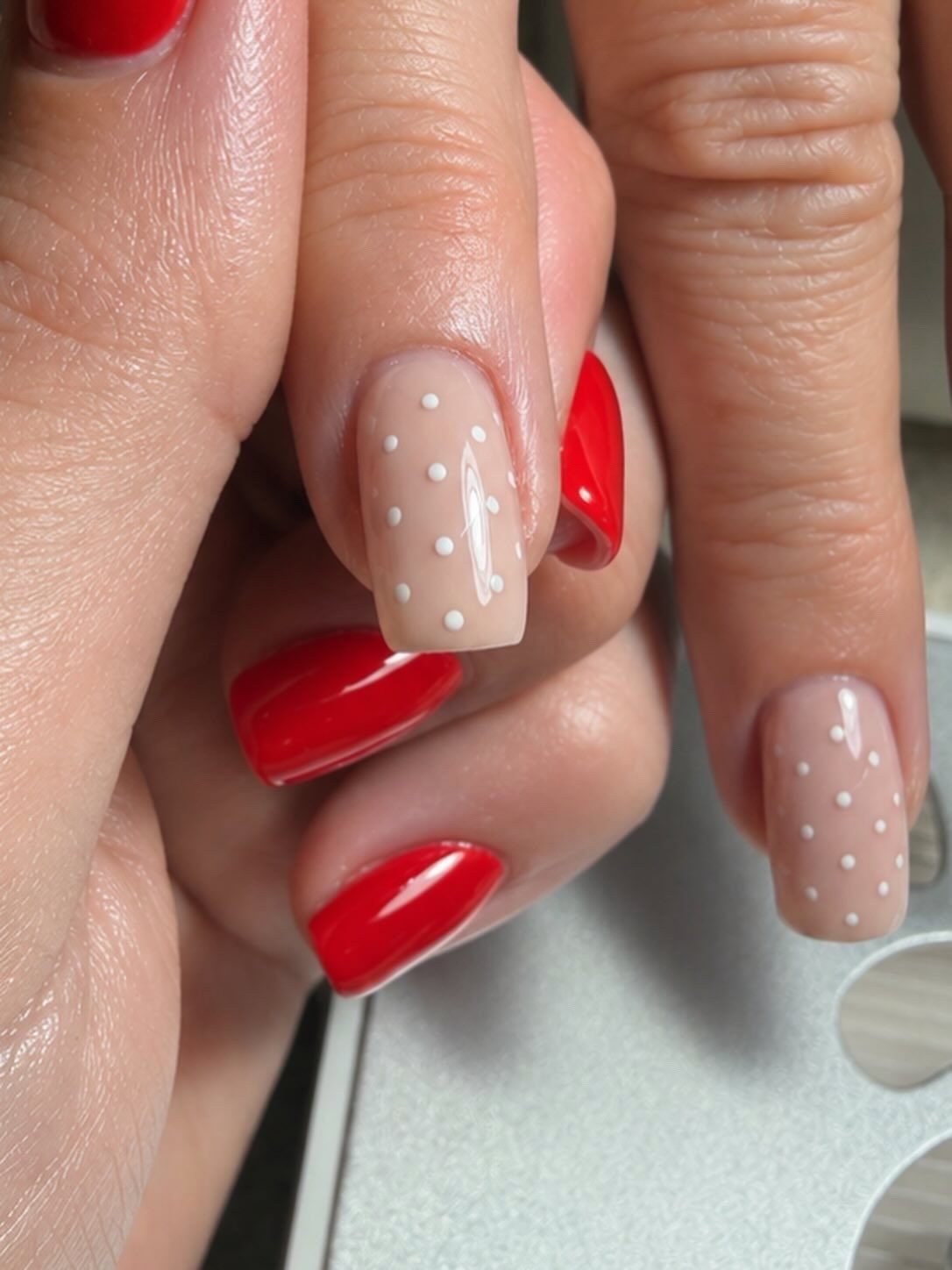 Red with dotted nude art by Kings Hill Manicures